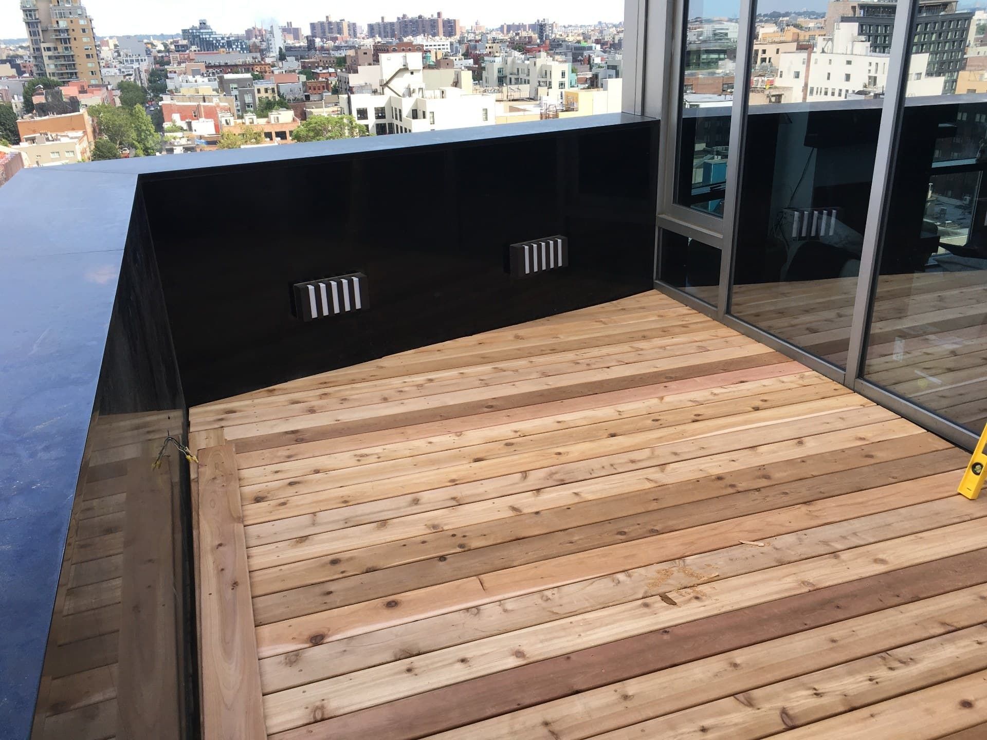 Rooftop terrace after install with cedar decking and black metal surround