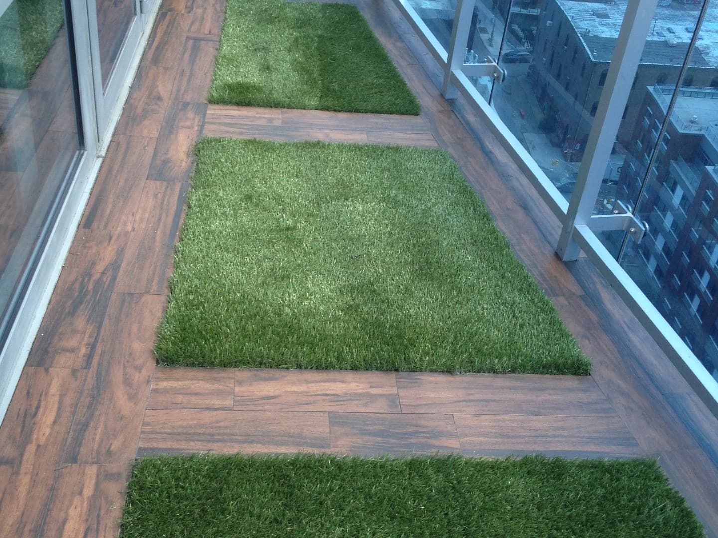 High-rise balcony after install with wood-look tile and turf inlays