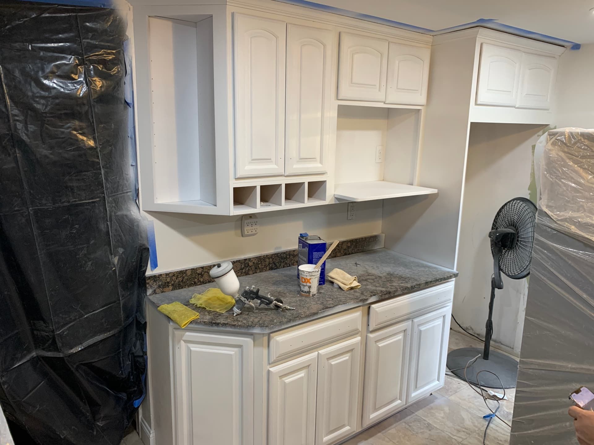 Cabinets sprayed white during refinishing, mid-project