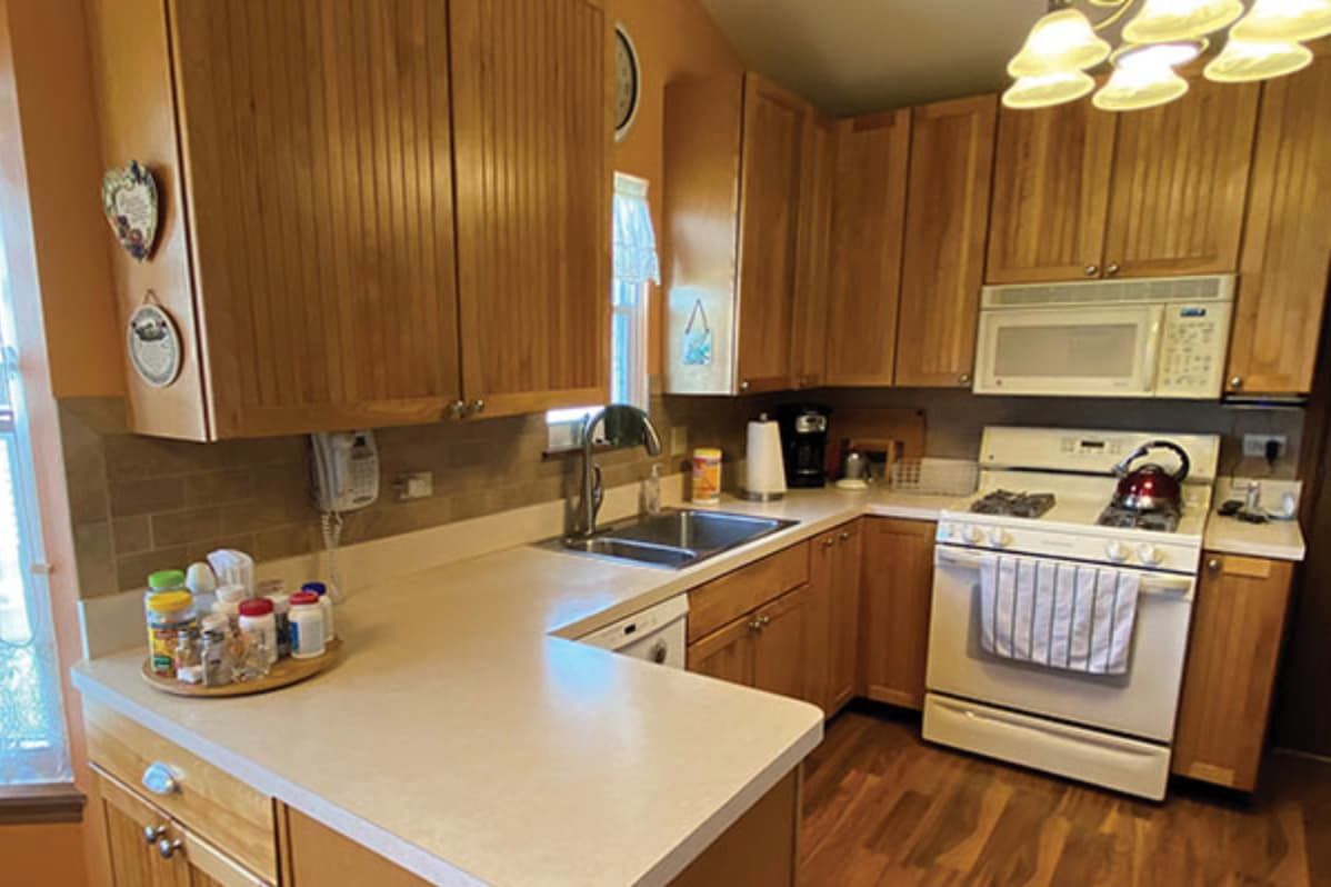 Dated honey oak cabinets and laminate counters before refinishing