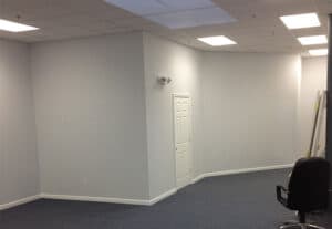 Repainted open office space with updated baseboards