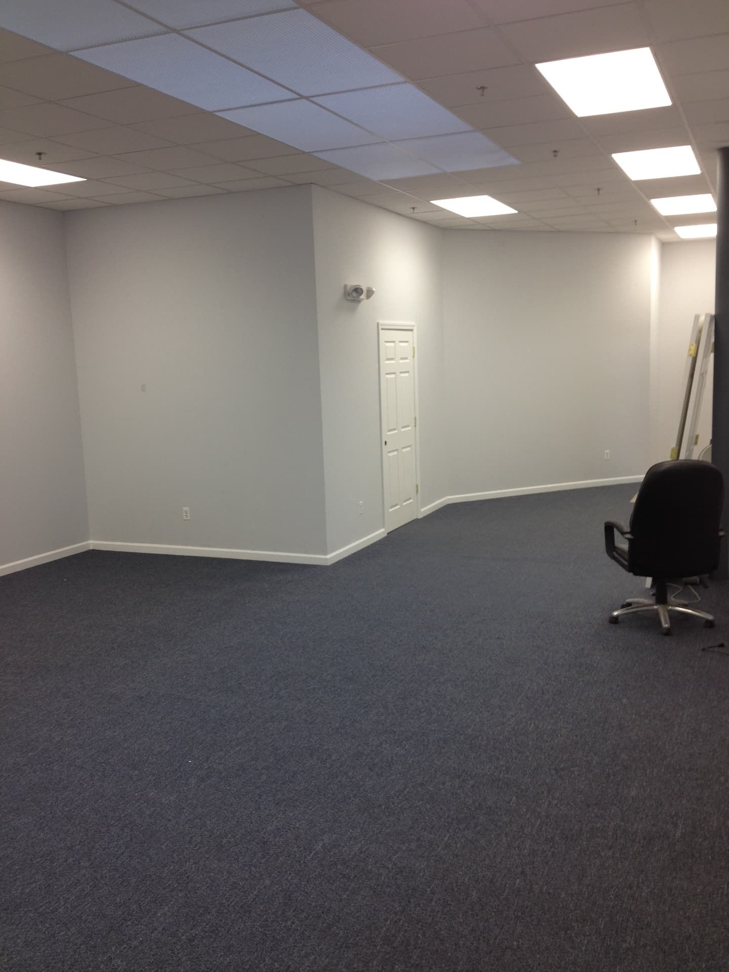 Finished commercial office space with fresh paint, drop ceiling, and new carpet