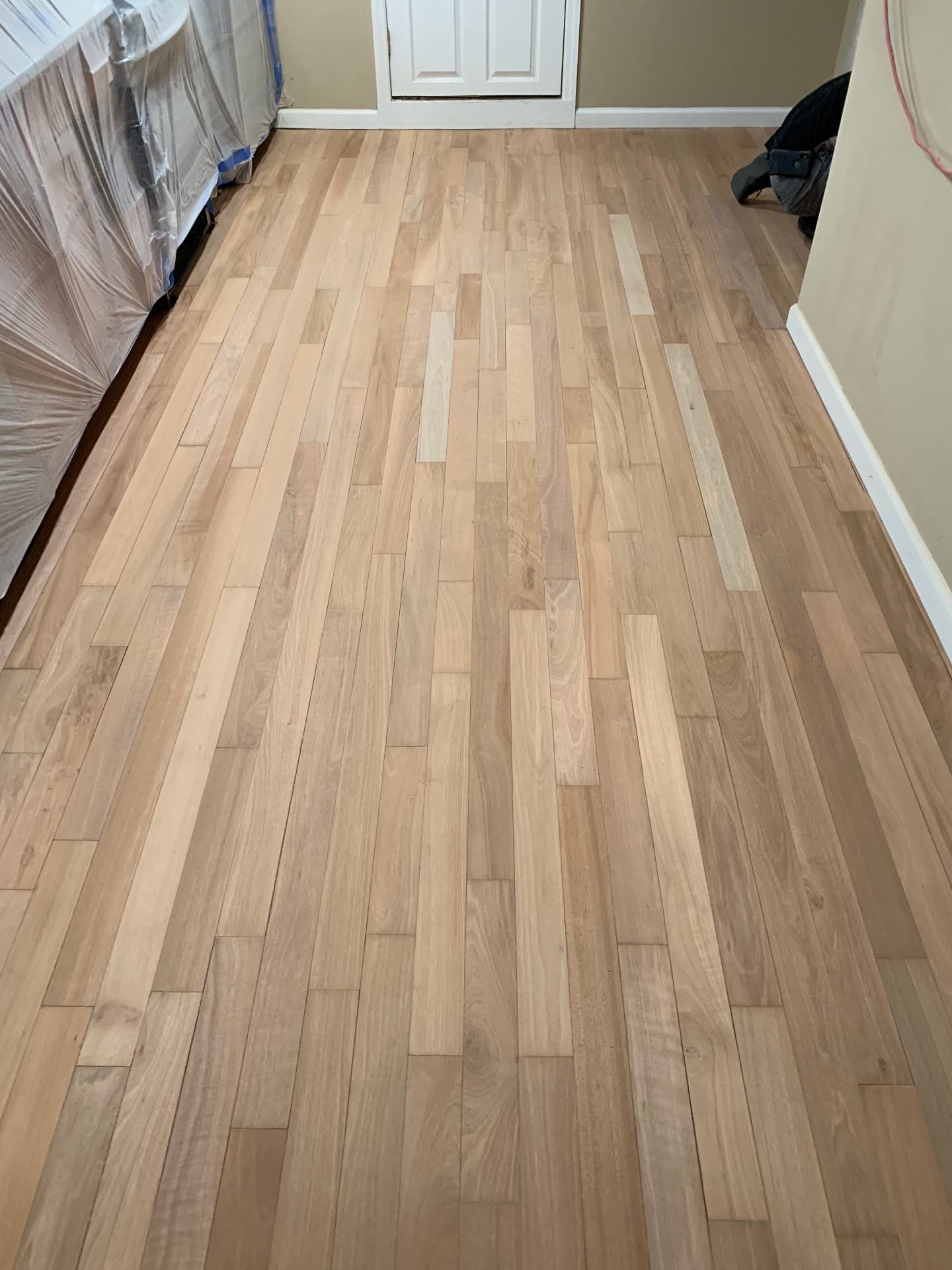 Raw unfinished hardwood floor before staining