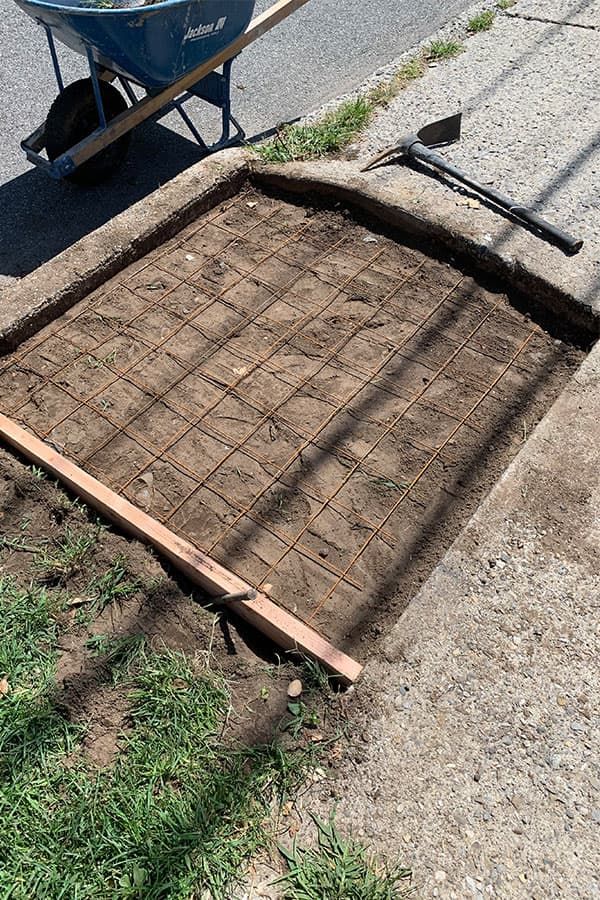Square concrete pad formed and reinforced with rebar grid, ready for pour