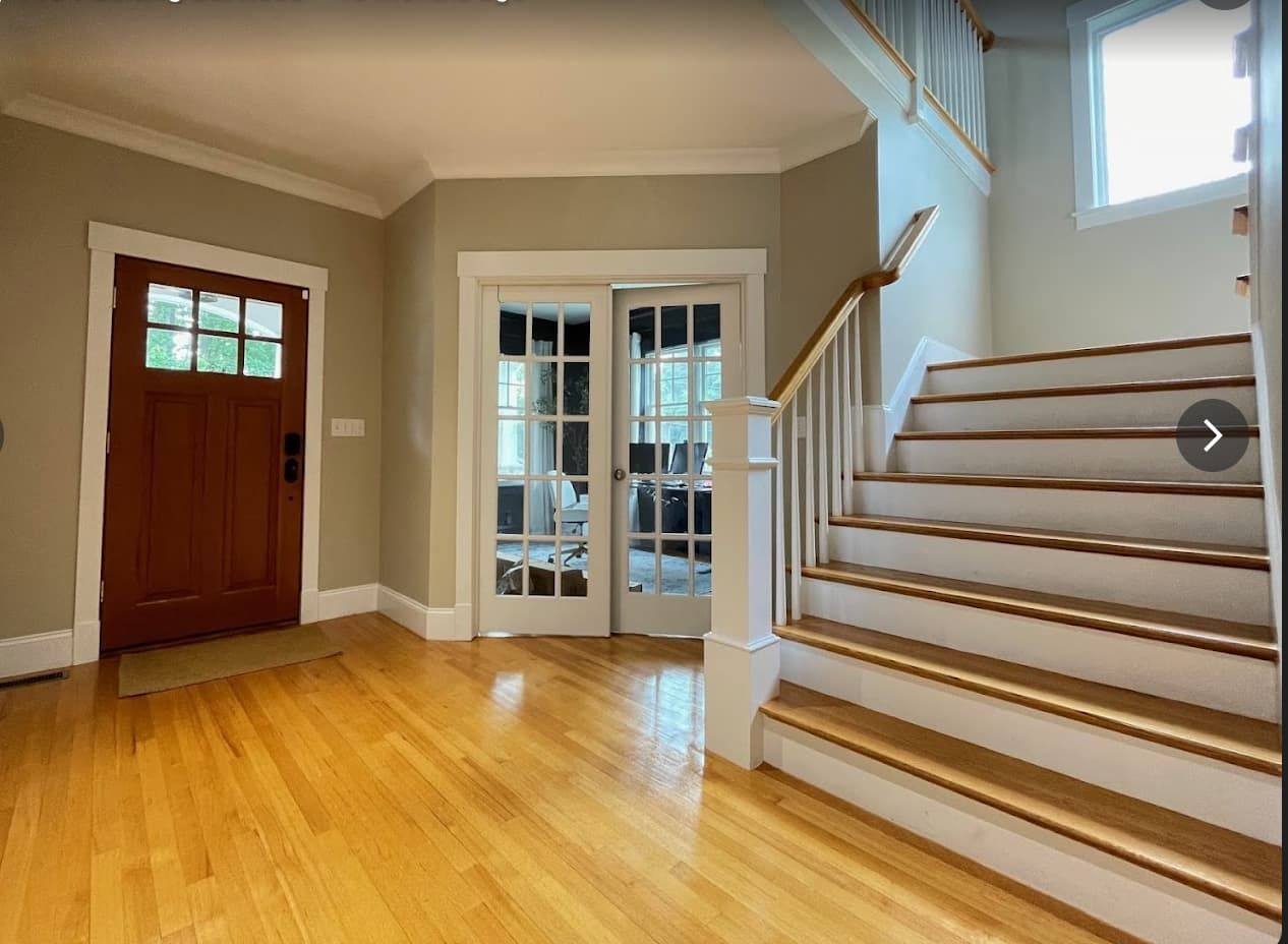 Freshly painted living room with mounted TV and warm gray walls
