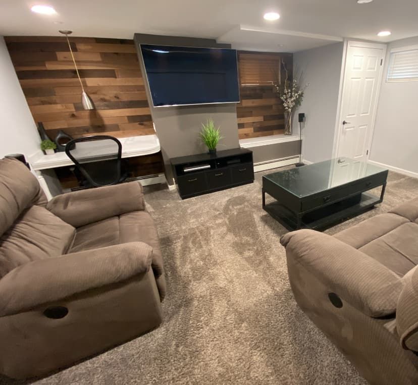 Basement living area after paint, wood accent wall, and refresh